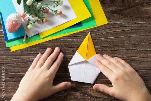 Origami instruction, step 7. The child fold the origami Easter chick. Handmade. The project of children's creativity, crafts, crafts for children.