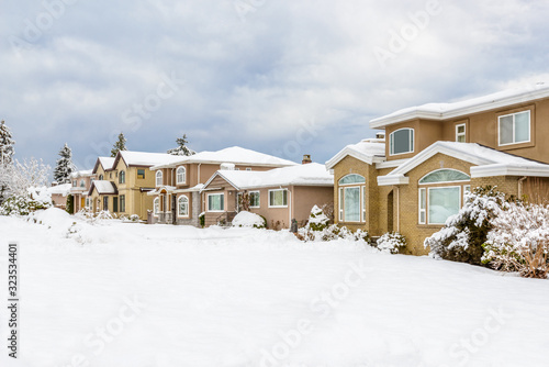 A perfect neighborhood. Houses in suburb at snow winter in the north America.