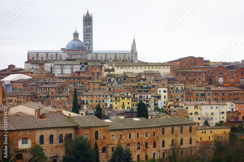 Panaroma of the city of Siena on a cloudy day..Roofs, characteristic houses and the Cathedral.