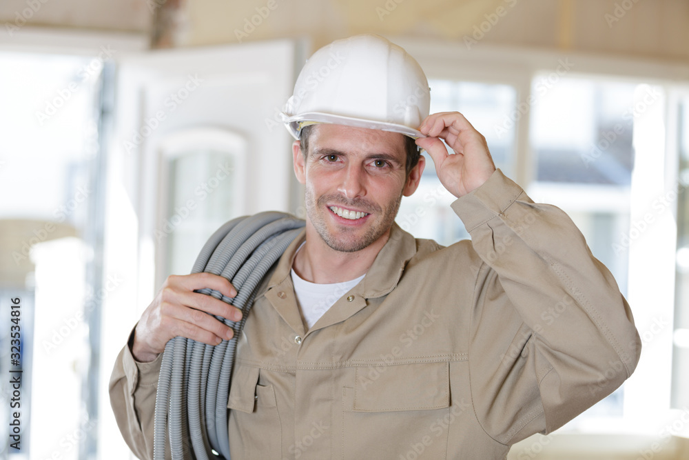 close up of electrician fitting wiring on construction site close up of electrician fitting wiring on construction site