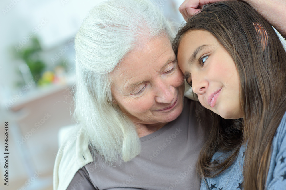 loving grandmother comforting her granddaughter