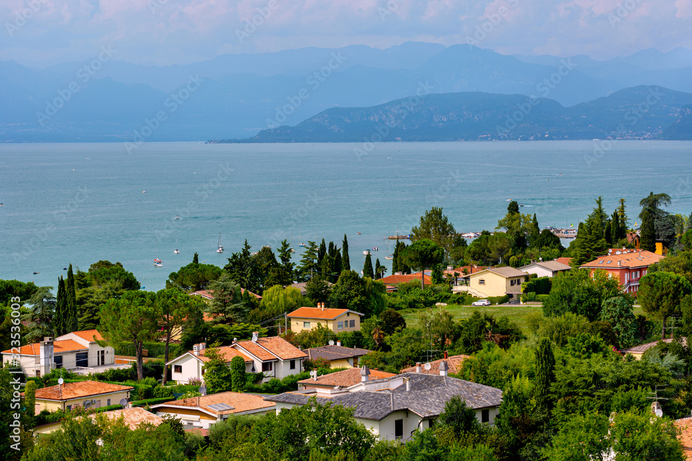 View of Lake Garda, summer landscape. Blue lake, mountayns Alps. Castelnuovo del Garda, Italy - August, 13 2019: Gardaland Theme Amusement Park in Castelnuovo Del Garda, Verona, Italy.