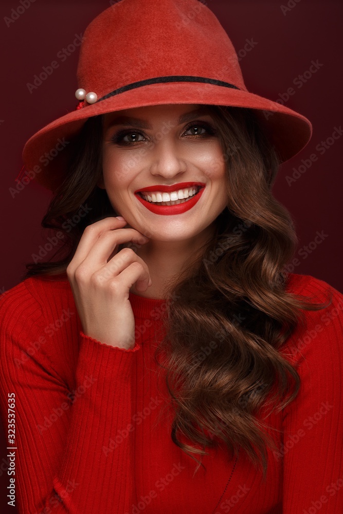 Beautiful sexy woman in a fashionable hat, with classic make-up, wave hair and red lips. Beauty face.