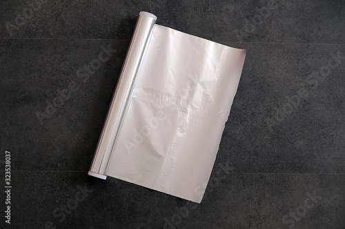 aluminum foil, rolled aluminum foil, close-up on a black background,