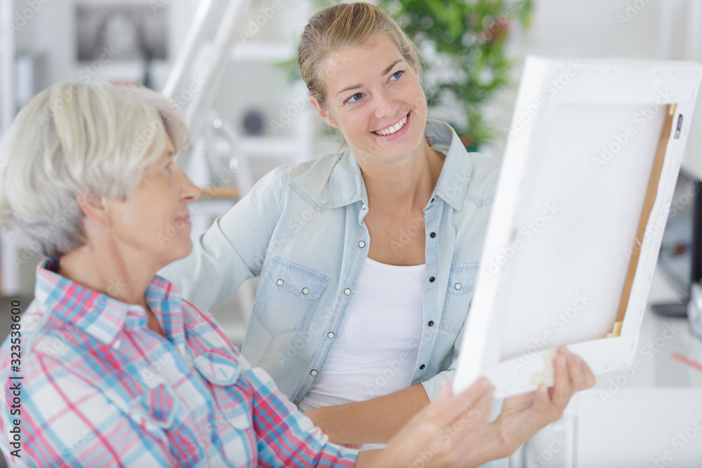 Fototapeta premium pretty mother and daughter talking about frames