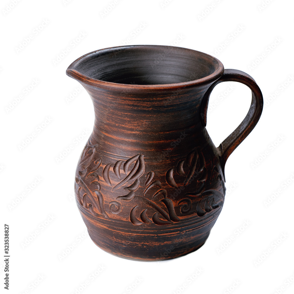 ceramic jug with handle isolated on white background. handicraft pattern on pot.