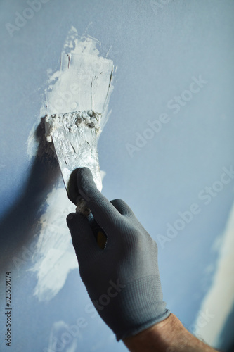Close up of unrecognizable construction worker building dry wall while renovating house, copy space photo