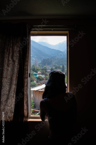 woman looking through window