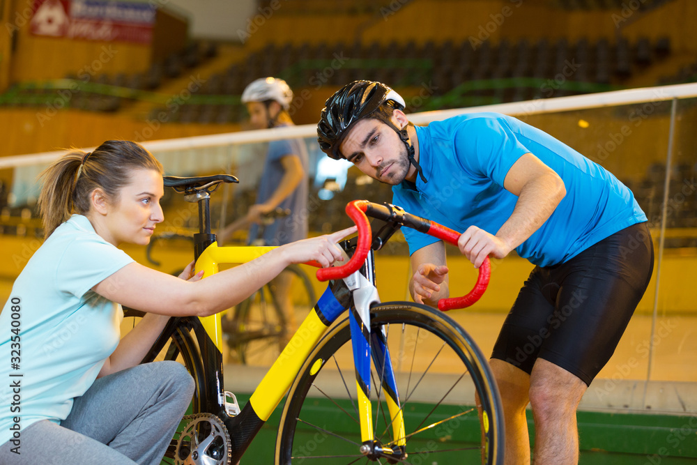 cyclist and coach in a velodrome