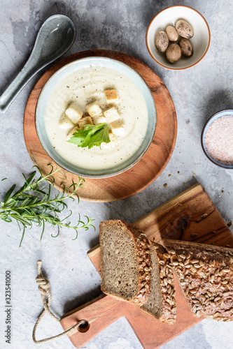 Creamy celery and kohlrabi soup topped with croutons and served with wholemeal bread