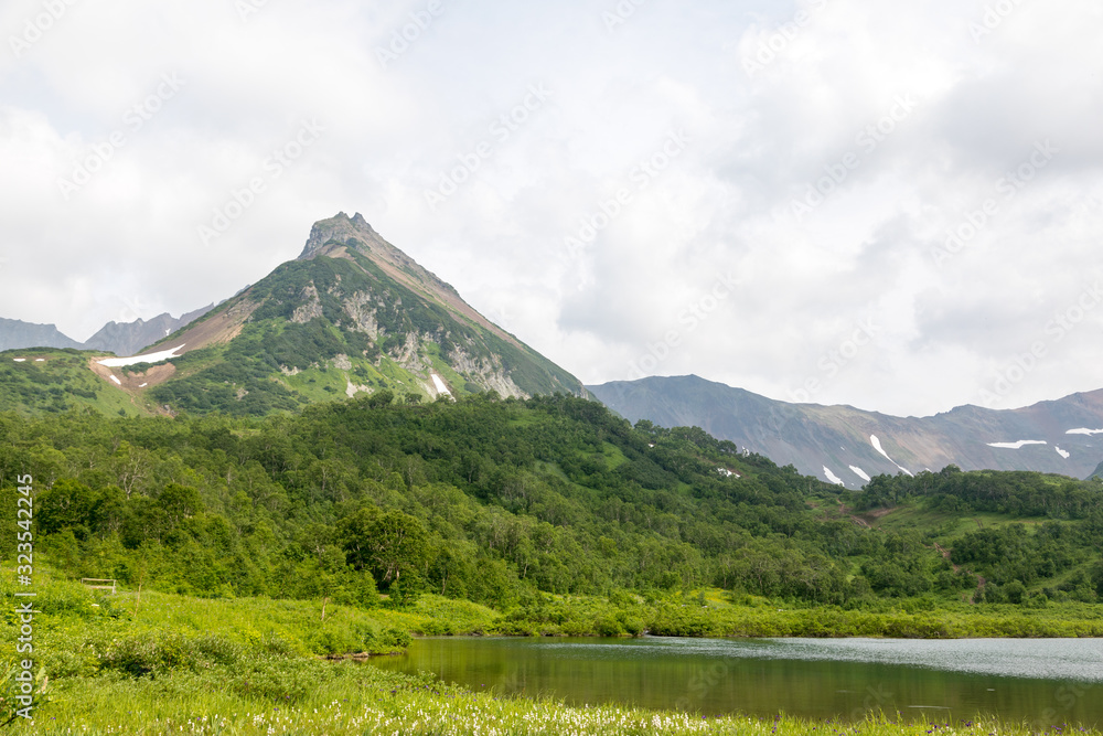 Vachkazhets mountain range, Kamchatka Peninsula, Russia. These are the remains of an ancient volcano, divided as a result of a strong eruption into several parts. Regional monument of nature. Vachkazhets mountain range, Kamchatka Peninsula, Russia. These are the remains of an ancient volcano, divided as a result of a strong eruption into several parts. Regional monument of nature.