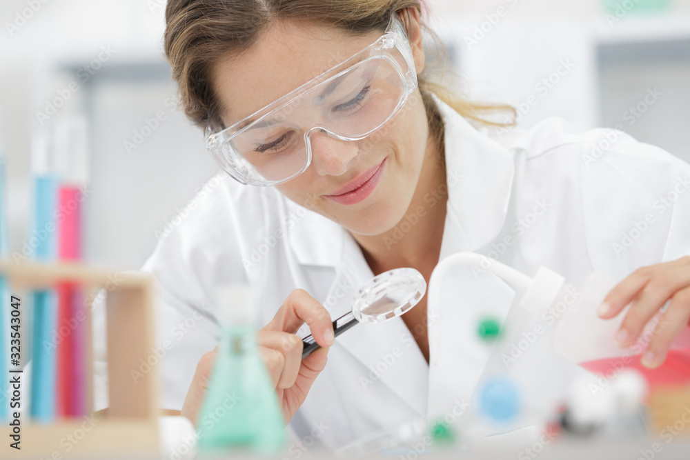 happy female worker wearing a mask in lab happy female worker wearing a mask in lab