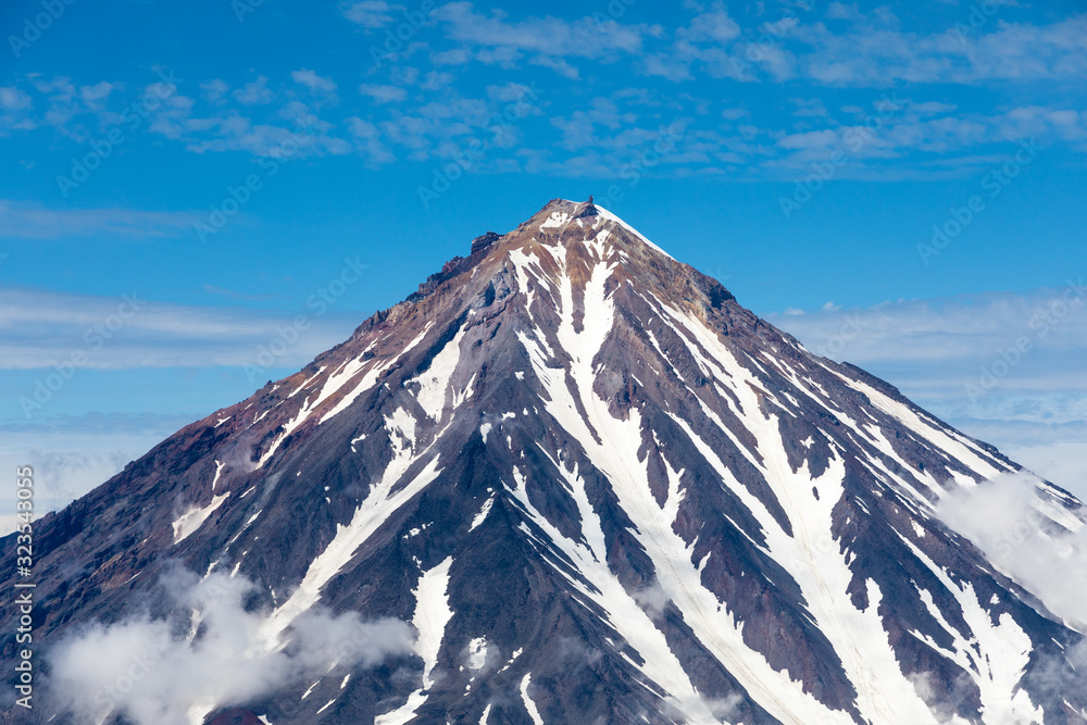Koryaksky volcano, Kamchatka peninsula, Russia. An active volcano 35 km north of the city of Petropavlovsk-Kamchatsky. The absolute height is 3430 meters above sea level. Koryaksky volcano, Kamchatka peninsula, Russia. An active volcano 35 km north of the city of Petropavlovsk-Kamchatsky. The absolute height is 3430 meters above sea level.
