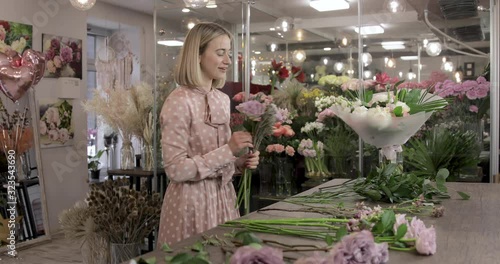 Florist woman make a bouquet of beautiful flowers. Small business owner and beautiful florist woman