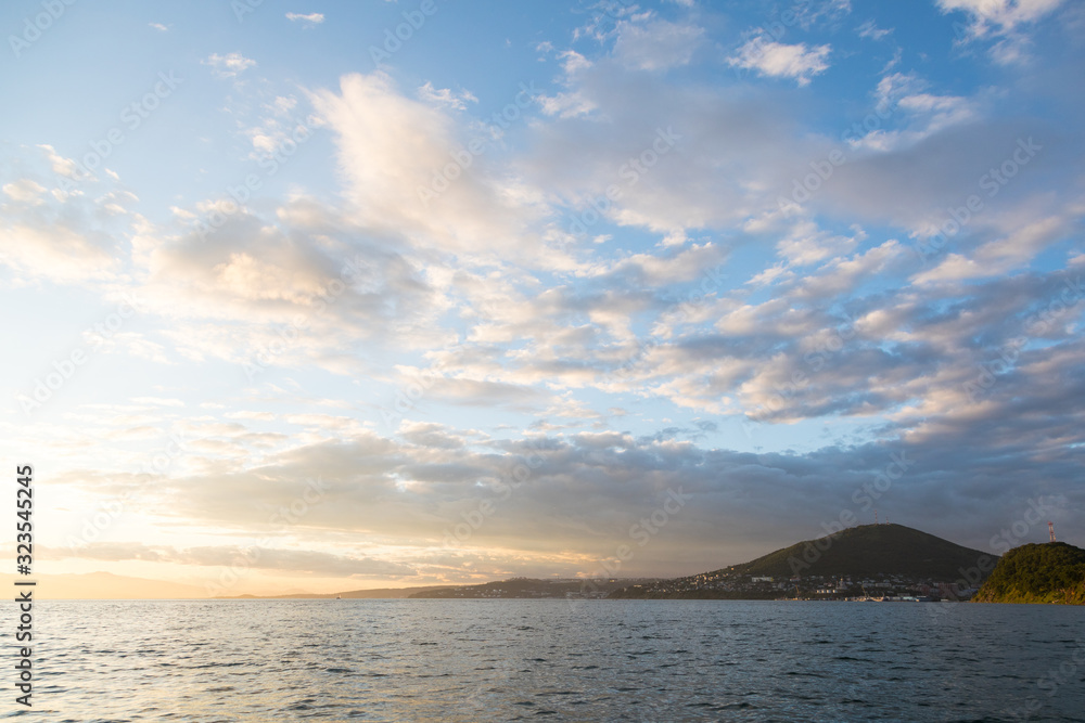 Golden sunset in the sky over the Avacha Bay, Kamchatka Peninsula, Russia.