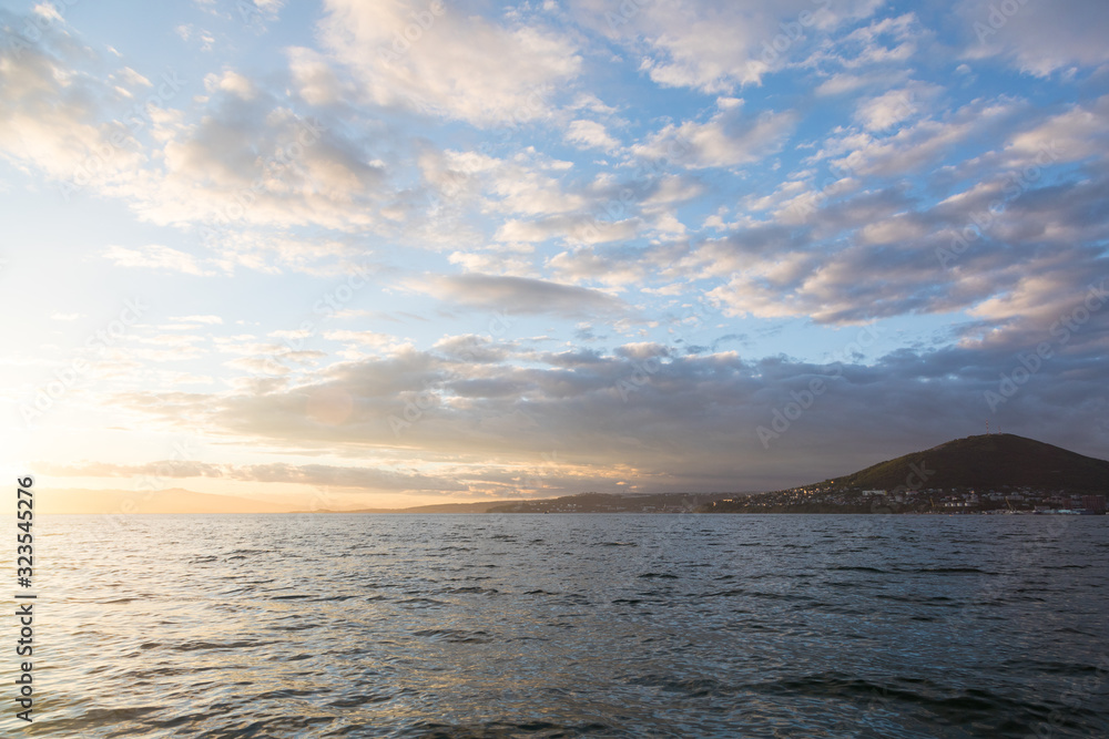 Fototapeta premium Golden sunset in the sky over the Avacha Bay, Kamchatka Peninsula, Russia.