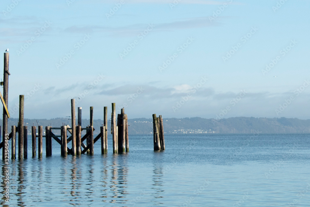 Pilings in water with sky