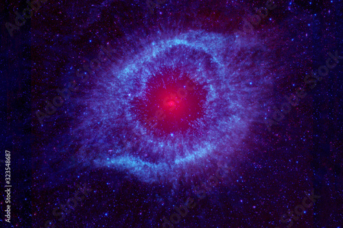 The space nebula is round shaped with a core. Elements of this image were furnished by NASA.