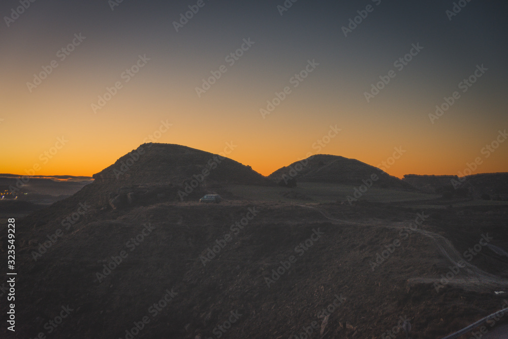 landscape photography of mountains at sunset, backlight with orange effect