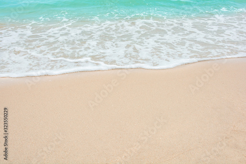 Summer beach concept - Soft wave of sea on empty sandy beach Background with copy space.