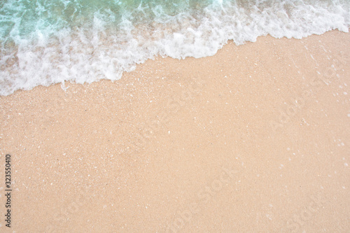 Summer beach concept - Soft wave of sea on empty sandy beach Background with copy space.