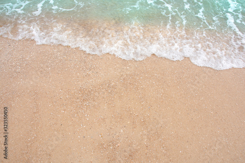 Fototapeta Naklejka Na Ścianę i Meble -  Summer beach concept - Soft wave of sea on empty sandy beach Background with copy space.