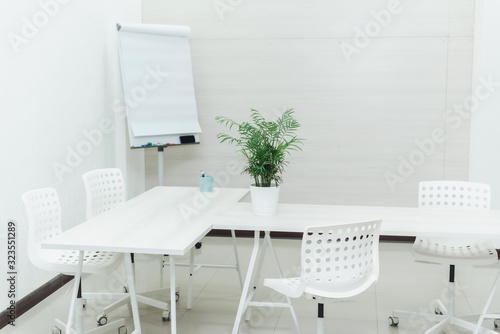 Small bright empty office with chairs, a table and a flipchart. A small cozy room for study at the university. Copyspace, template