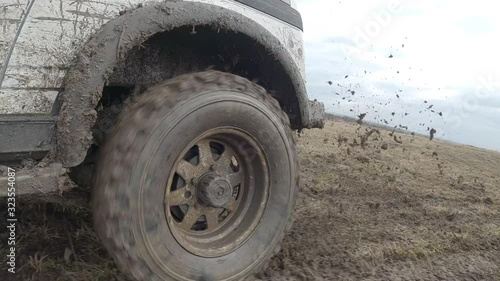 4x4 offroad car spin wheel in the water and mud slow motion
