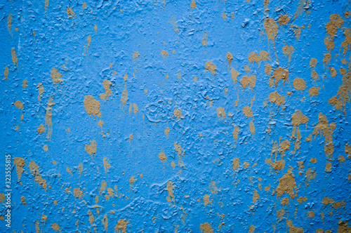 Blue iron old scratched ragged sheet metal wall with spots of dirt and drops of earth. Texture, background