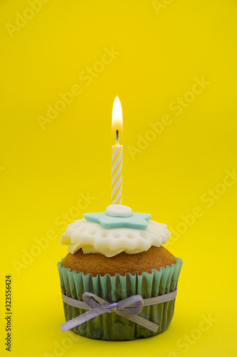 Cupcake decorated with white and blue cream.