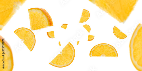 Sliced fruit falling background. Orange citrus tangerine flight in air with clipping path.