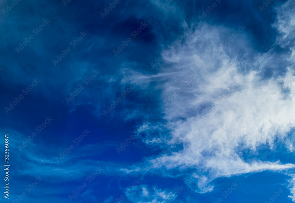 Bright blue sky with clouds, background for design, decoration or wallpaper Bright blue sky with clouds, background for design, decoration or wallpaper