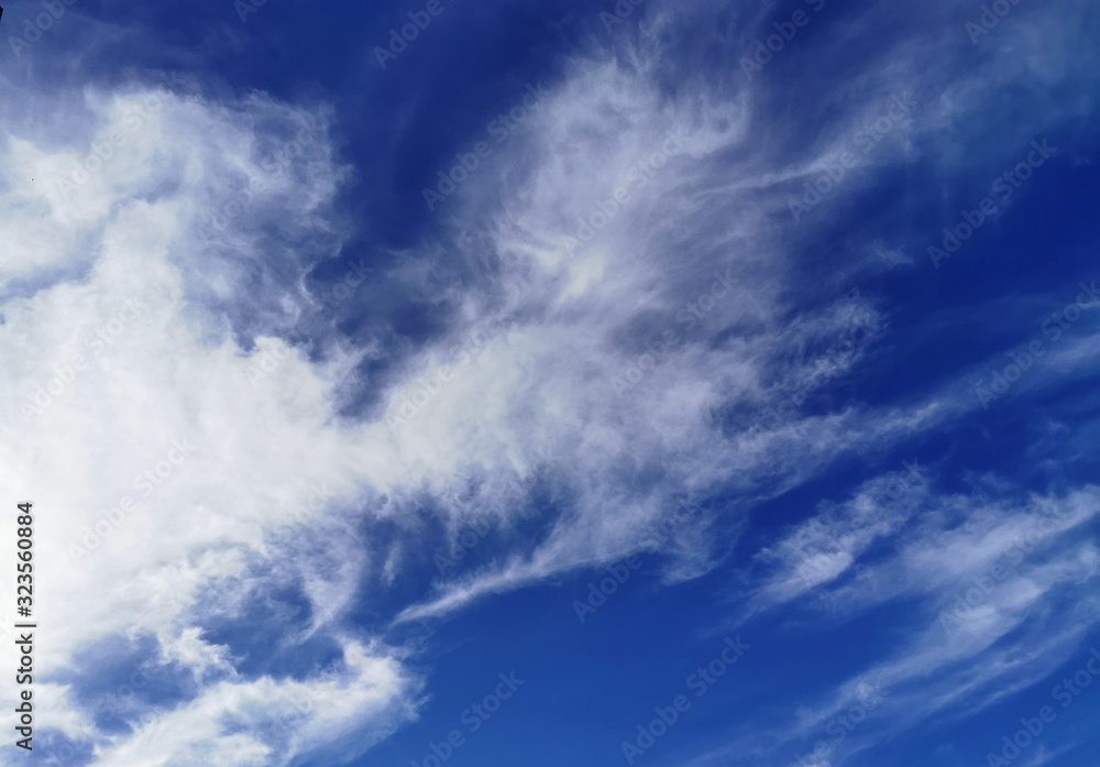 Bright blue sky with clouds, background for design, decoration or wallpaper