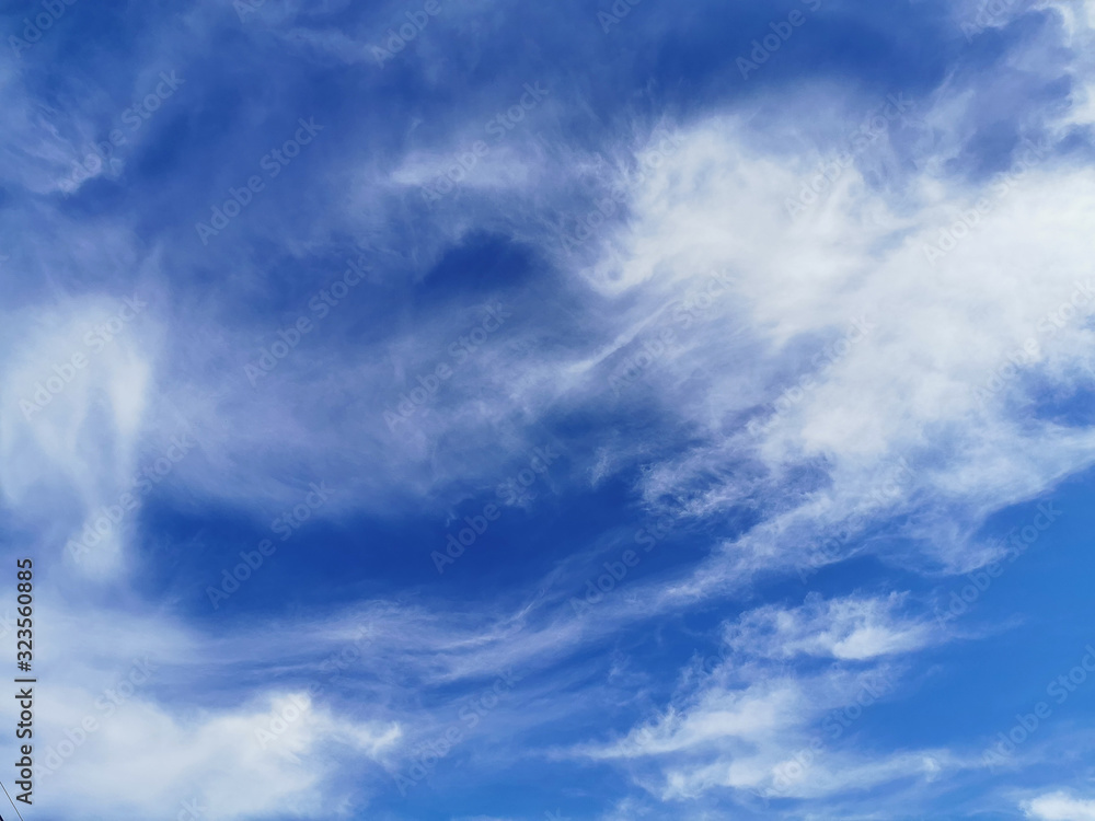 Bright blue sky with clouds, background for design, decoration or wallpaper Bright blue sky with clouds, background for design, decoration or wallpaper