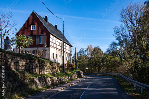 Fototapeta Naklejka Na Ścianę i Meble -  farmhouse  above the country road