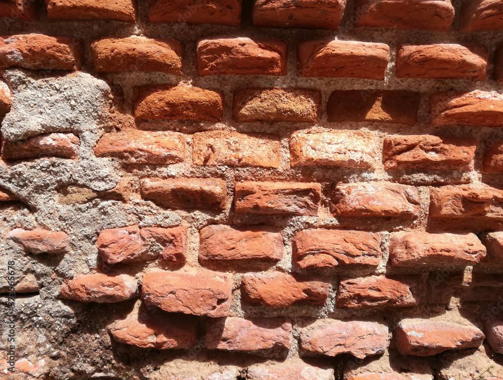 Fototapeta premium Reddish construction, texture. Ancient and genuine wall. Solid red clay brick very old.