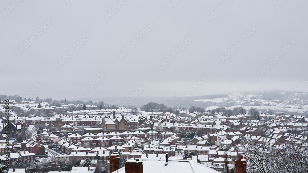 View over snow covered rooftops of homes in the city of Sheffield, Yorkshire, England.
