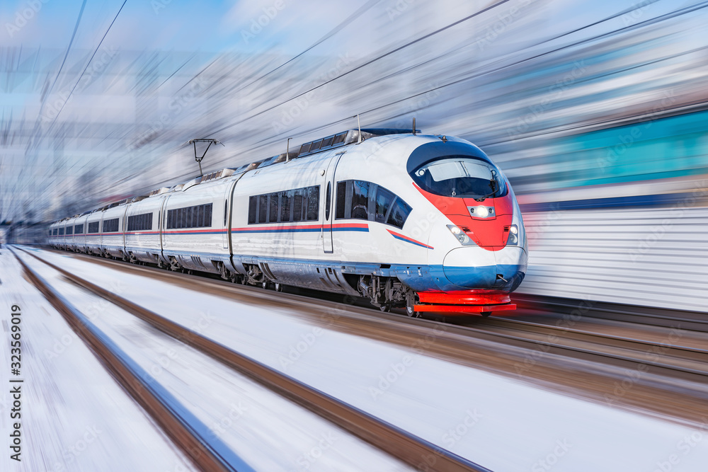 Highspeed train approaches to the station platform at winter day time.