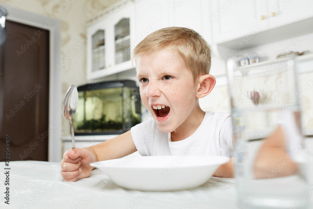 boy is looking at an empty plate boy is looking at an empty plate