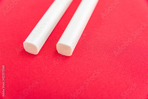 White chopsticks on the red table