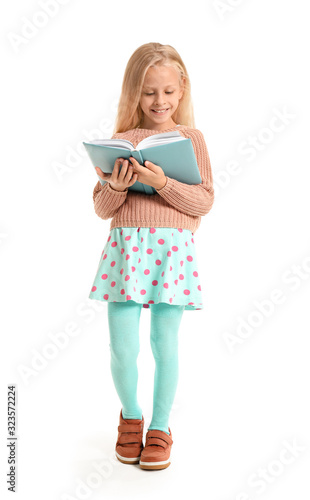 Little girl reading book on...