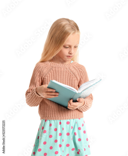 Little girl reading book on...