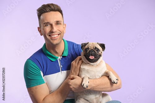 Handsome man with cute pug ...