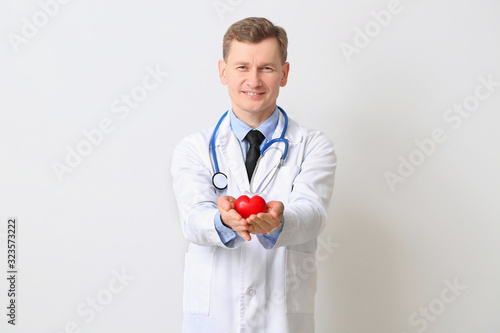 Male cardiologist on light ...