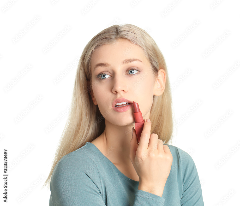 Beautiful young woman applying makeup on white background Beautiful young woman applying makeup on white background