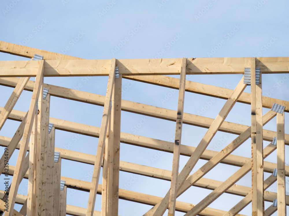 Obraz premium wood timber framing with truss plates for a residential construction project