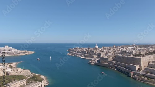 Wallpaper Mural Flies backwards over the Mediterranean Sea on the island of Malta, between the historical capital city of Valletta and Fort Manoel, boats and yachts in the frame. Aerial video Torontodigital.ca