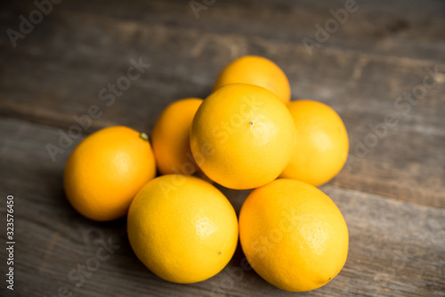 Fresh ripe lemons on the rustic background. Selective focus. Shallow depth of field.