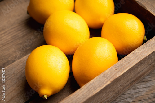 Fresh ripe lemons on the rustic background. Selective focus. Shallow depth of field.