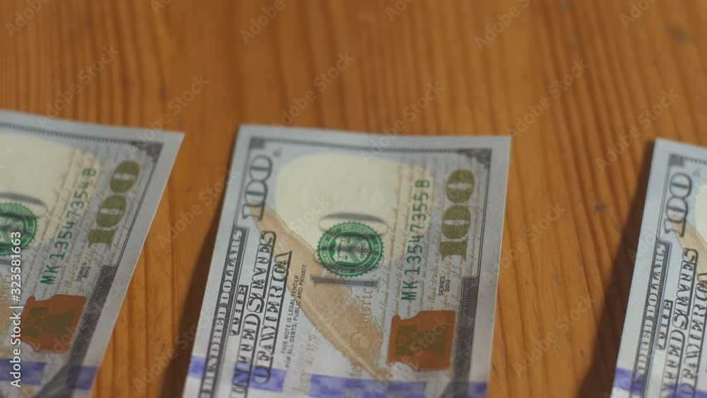 Man pays in cash one hundred dollar bills. Dollars money cash banknotes on table. Money profit calculation. Home economy finance. Personal budget. American currency business. Cash money payment. Man pays in cash one hundred dollar bills. Dollars money cash banknotes on table. Money profit calculation. Home economy finance. Personal budget. American currency business. Cash money payment.